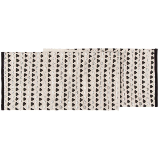 A beige and black woven table runner with a geometric pattern and velvet trim.